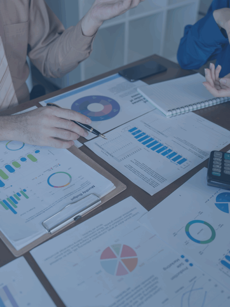 Papers on a desk with graphs and charts.