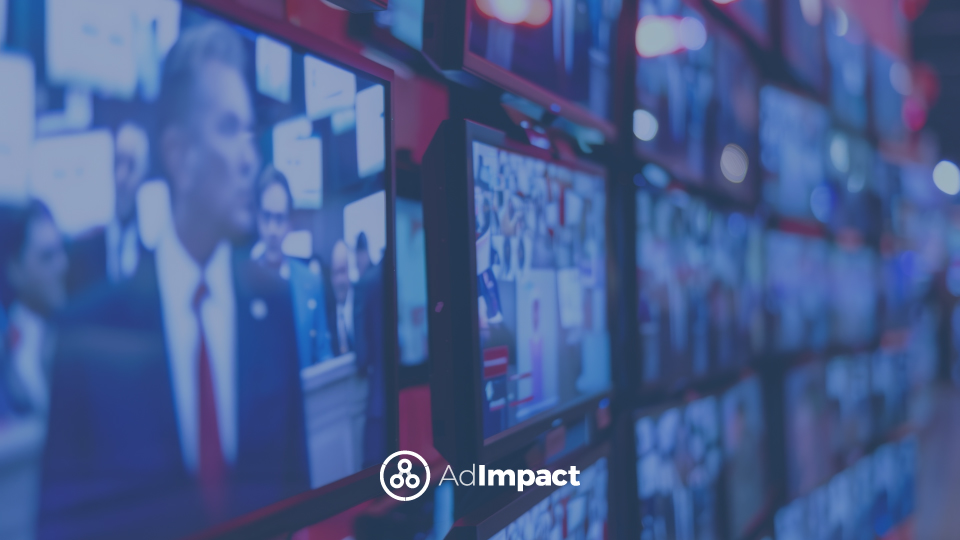 Wall of television screens displaying live news broadcasts and political coverage in a modern media control room, representing digital advertising and media monitoring.